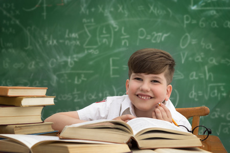 Cheerful smiling child at the blackboard. School conceptの写真素材