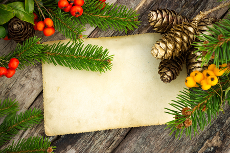 Christmas decoration with a paper roll for text on wooden tableの写真素材