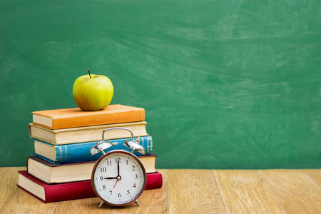 Back to school supplies over green  school blackboardの写真素材