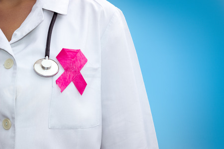 healthcare and medicine concept - female doctor with pink breast cancer awareness ribbonの写真素材