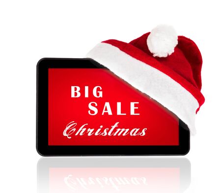 Tablet with red Santa hat  bow and Christmas sale on a screenの写真素材