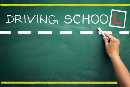 hand writing driving school on black chalkboardの写真素材