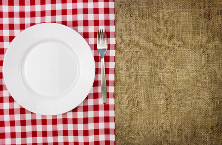 Rustic table setting, empty plate and fork with copy spaceの写真素材