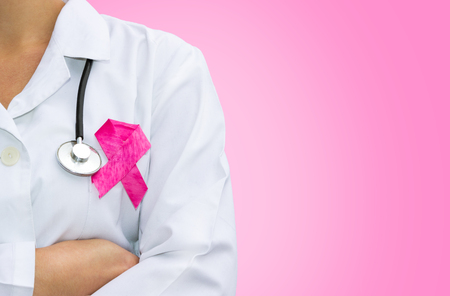 female doctor with pink breast cancer awareness ribbon, healthcare and medicine conceptの写真素材