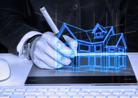 Architect drawing a futuristic sketch of house with the help of graphic tabletsの写真素材