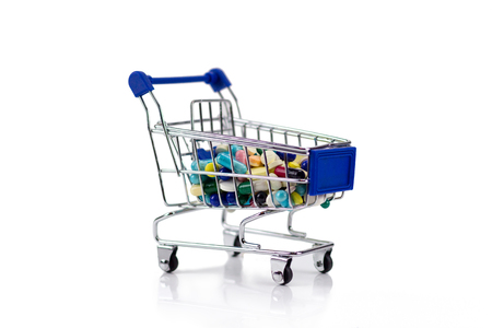 Pharmacy medicine. Shopping cart with pills and medical suppliesの写真素材