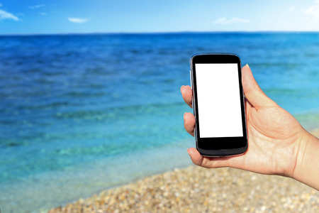 smartphone with beautiful sea shoreの写真素材