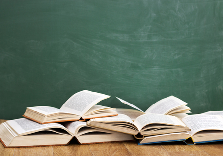 Open books front empty green blackboardの写真素材