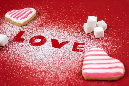 sweet Valentine's Day background with heart of icing sugar, heart shaped cookies and sugar cubesの写真素材
