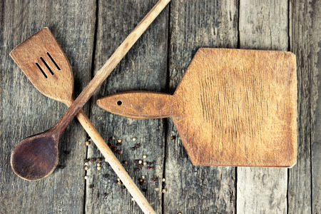 stylized cook - cutting board and wooden spoons on plankの写真素材