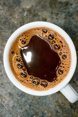 Coffee in white porcelain cupの写真素材