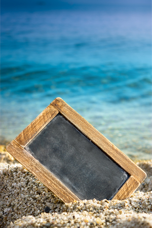 empty blackboard in the sand on beach, concept  tourism, summer, holidayの写真素材