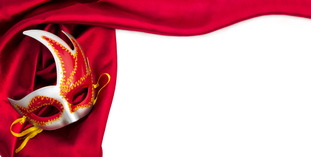 Carnival mask and red silk fabric, isolated over whiteの写真素材