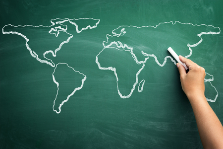 Hand drawing world map on a school blackboardの写真素材