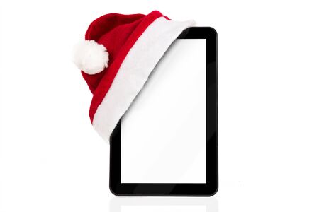 Christmas tablet computer with Santa hat, isolated over white backgroundの写真素材