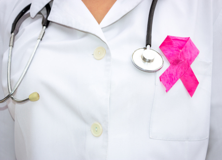 female doctor with  a red ribbon as a symbol of AIDSの写真素材