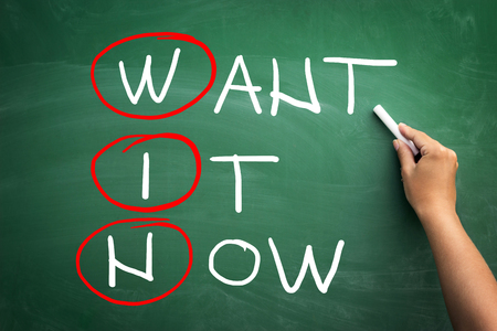 WIN - Want It Now,  handwritten chalk on green blackboardの写真素材