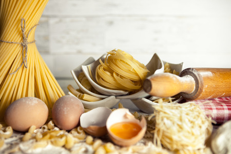 Spaghetti and tagliatelle with eggs and rolling pinの写真素材