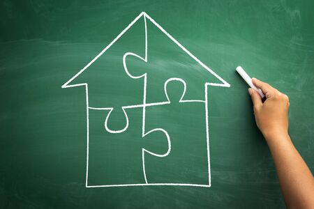 house drawing of puzzle pieces on chalkboard, concept every element is importantの写真素材