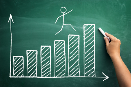 Stickman jumping on the diagram of business growth and successの写真素材