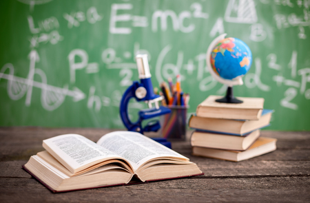 Microscope with book on the school deskの写真素材