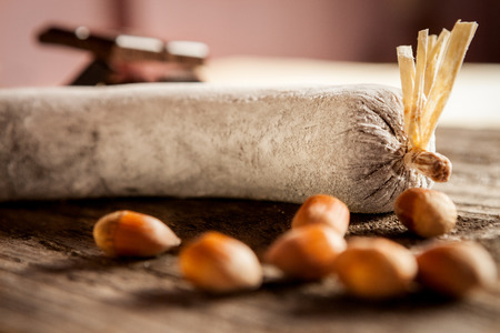 Close shot of chocolate salami with hazelnuts on wooden tableの写真素材