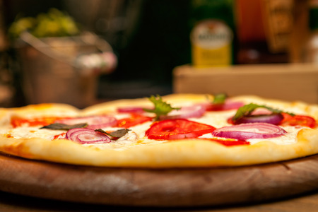 Delicious pizza served on plate in pizzeriaの写真素材