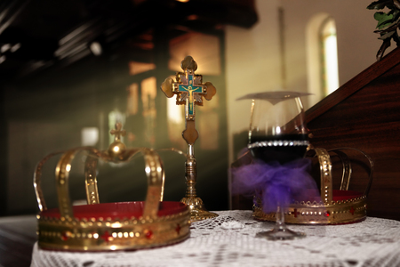 Wedding crowns and cross in churchの写真素材