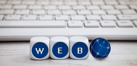 Letter dice with web text and white keyboard in the backgroundの写真素材