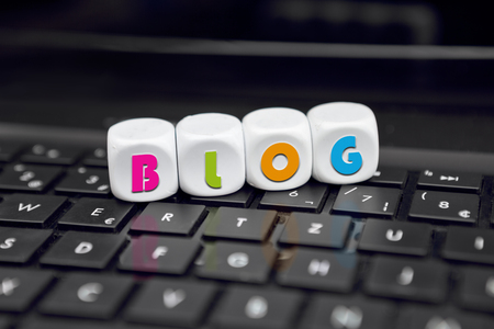 Letter dice on black keyboard with blog textの写真素材