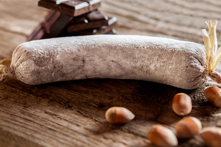 Chocolate sausage with hazelnuts on wooden backgroundの写真素材