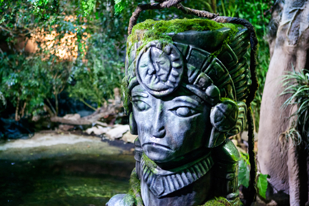 Head statue covered with mossの写真素材