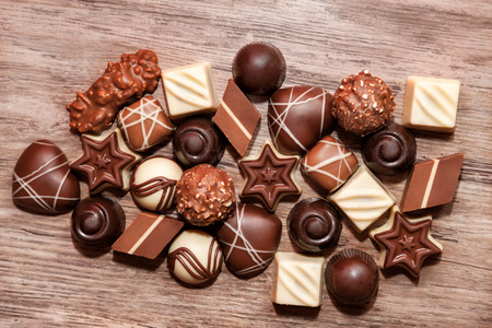 Sweet chocolate pralines on wooden backgroundの写真素材
