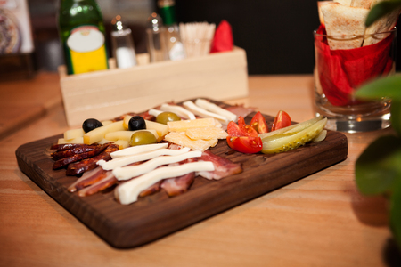 Delicious meat appetizer on wooden boardの写真素材