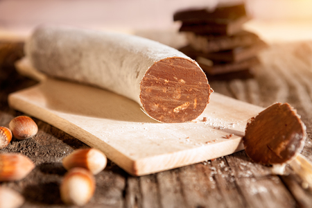 Sliced chocolate sausage on chopping boardの写真素材