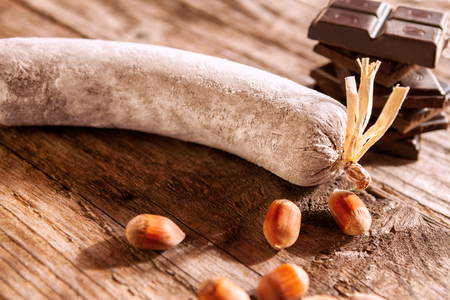 Chocolate salami with decorations on wooden tableの写真素材