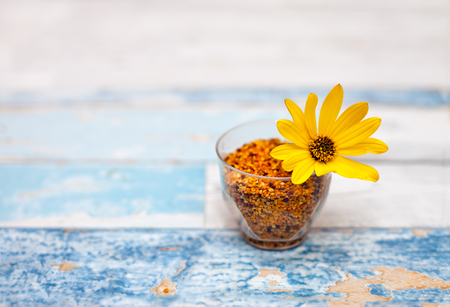 Plastic glass with pollen on the tableの写真素材