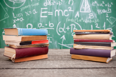 Pile of different books on school tableの写真素材