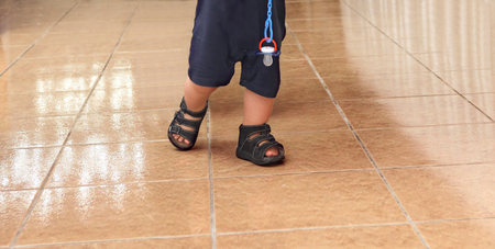 Toddler baby making his first stepsの写真素材
