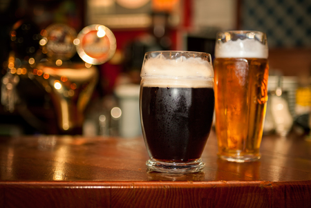 Cold dark beer with light beer in glassesの写真素材