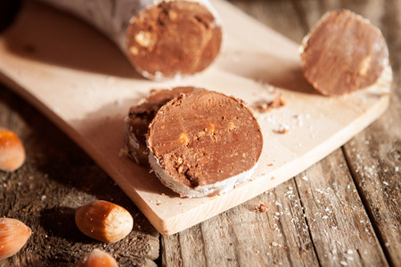 Delicious sliced chocolate sausage on wooden tableの写真素材