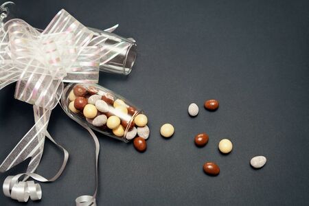 Sweet chocolate candy in glass decorated with ribbonの写真素材