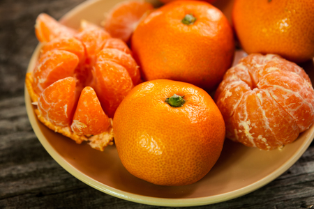 Fresh and organic clementines on plateの写真素材