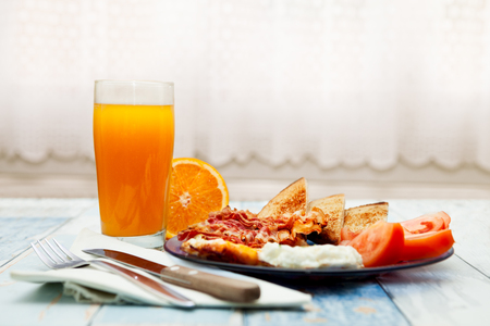 Served homemade breakfast,bacon,toast and orange juiceの写真素材