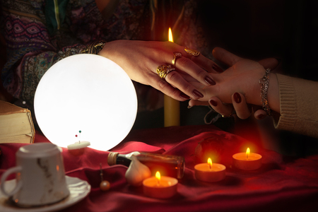 Fortune teller woman during session doing palm readingの写真素材