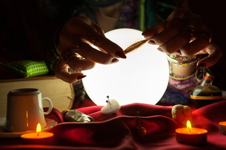 Hands of gypsy woman holding a hair bundle for witchcraftの写真素材