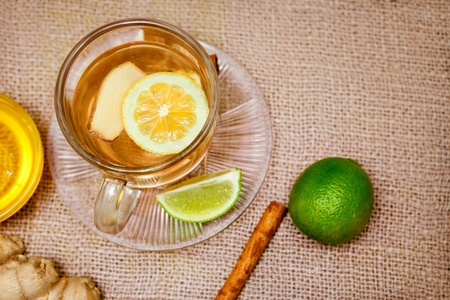 Ginger tea with lemon and lime on the tableの写真素材