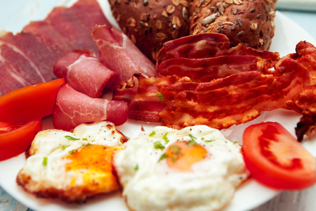 Close up of breakfast with eggs,bacon,ham and integral buns-Chrono dietの写真素材