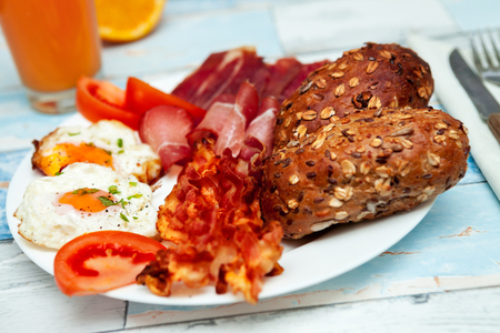 Fried eggs, integral buns, bacon and tomatoes-Chrono dietの写真素材