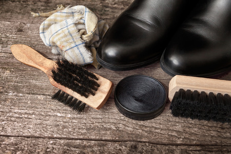 Wooden brushes and polish cream for shoes and boots on wooden tableの写真素材